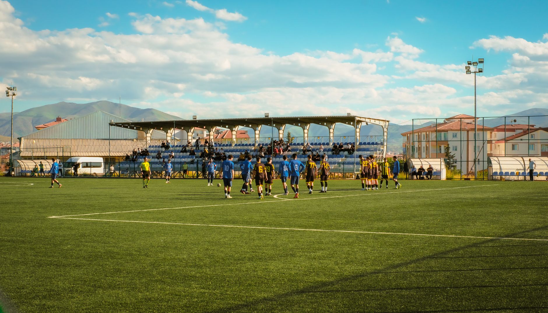 An outdoor soccer game with teams playing on a grass field in Malatya, Turkiye.